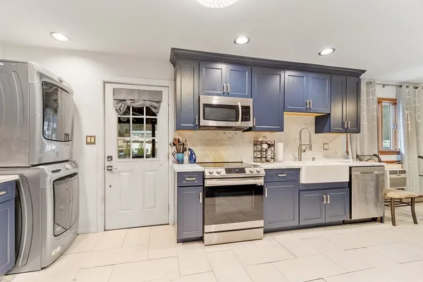 a kitchen with stainless steel appliances granite countertop a refrigerator stove a sink and dishwasher