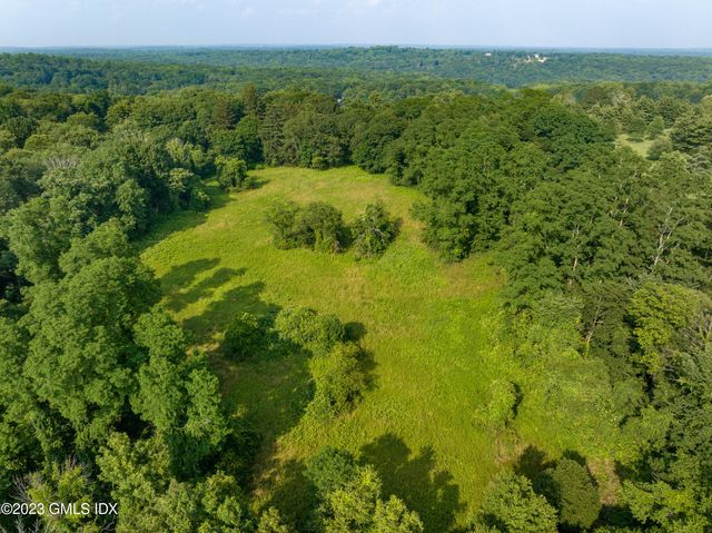 a view of a big yard with large trees