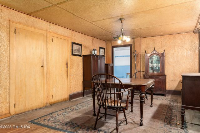 a dining room with furniture window and wooden floor