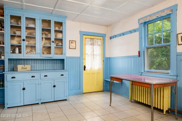 a kitchen with a window and cabinets
