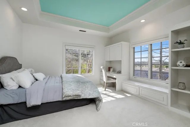 a bedroom with a bed couch and a window