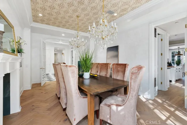 a view of a dining room with furniture and chandelier