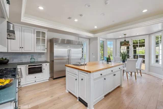 a kitchen with stainless steel appliances granite countertop a stove and a refrigerator