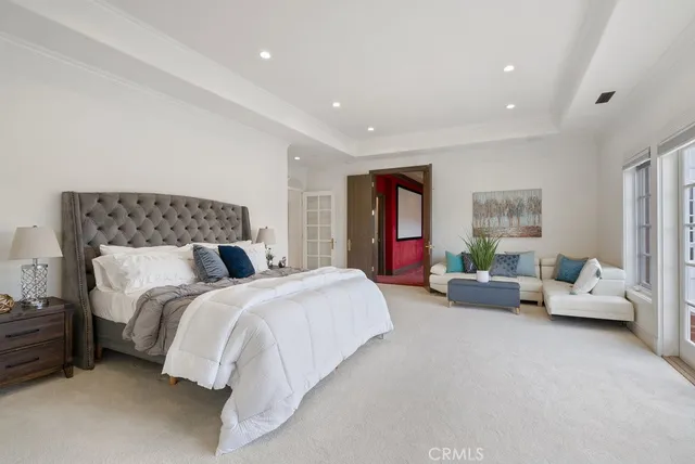 a spacious bedroom with a bed and couch