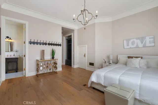 a bedroom with a bed and a chandelier