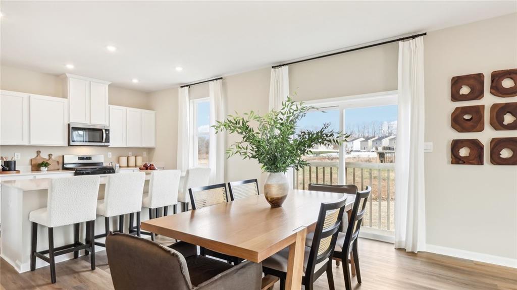 207 Joseph Drive Hunker, PA 15639 - Photo 6 of 25 a view of a dining room with furniture and wooden floor