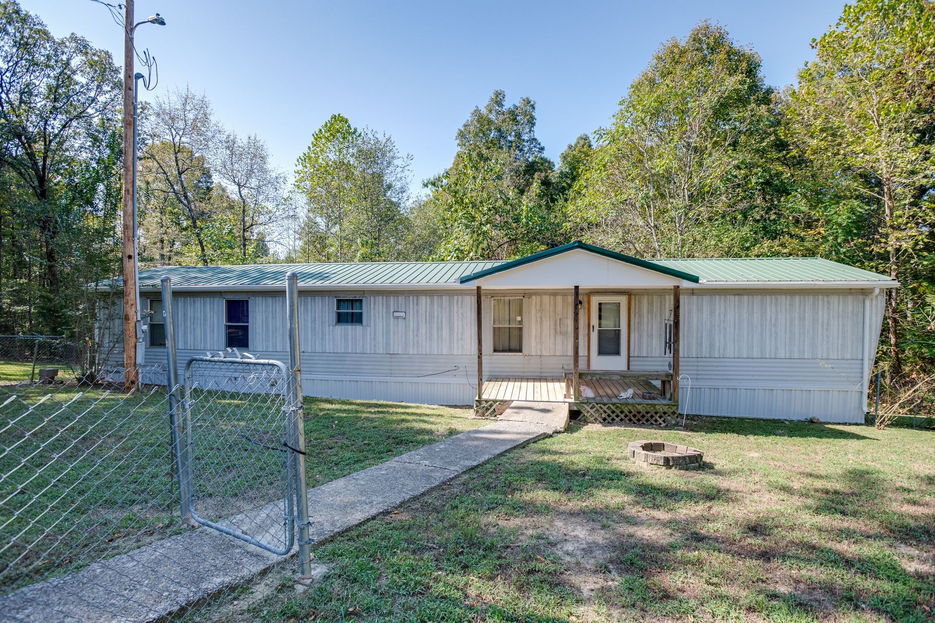 1810 Jim Kim Road Cunningham, TN 37052 - Photo 1 of 37 a front view of a house with a yard and fence