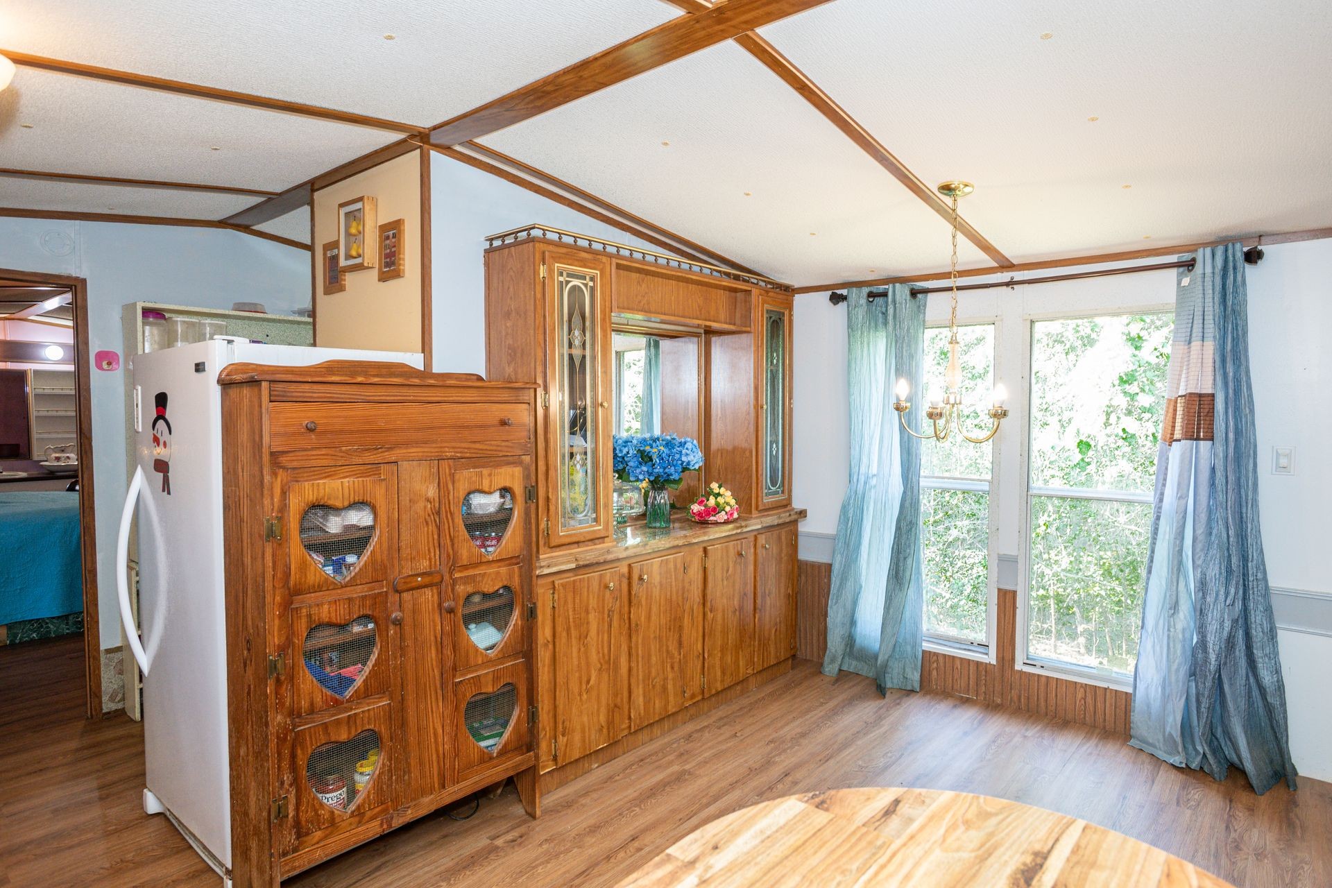 1810 Jim Kim Road Cunningham, TN 37052 - Photo 18 of 37 a view of a hallway with wooden floor and windows with curtains