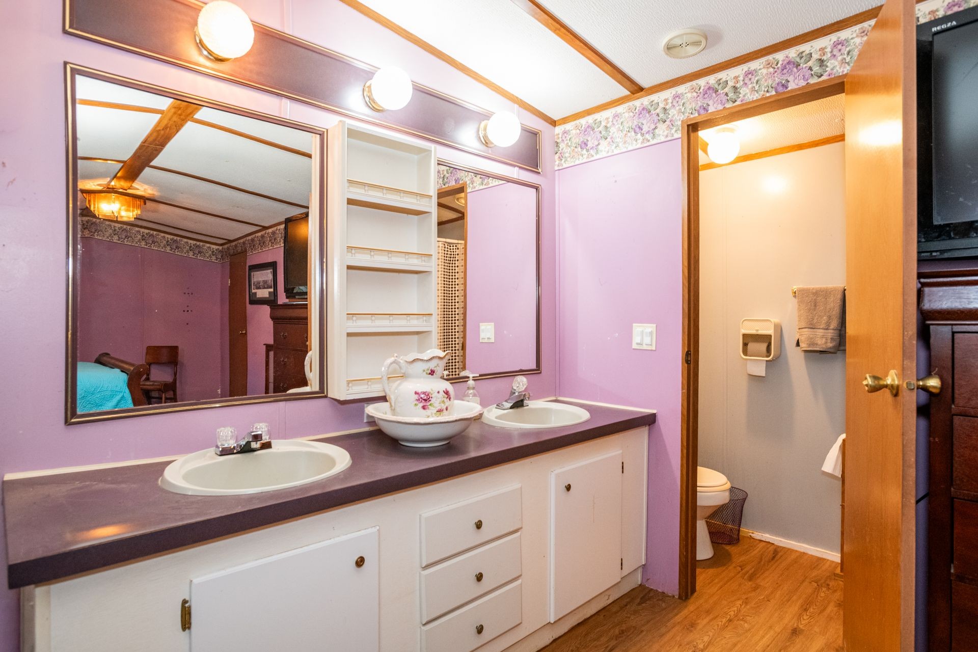 1810 Jim Kim Road Cunningham, TN 37052 - Photo 7 of 37 a bathroom with a double vanity sink and a mirror