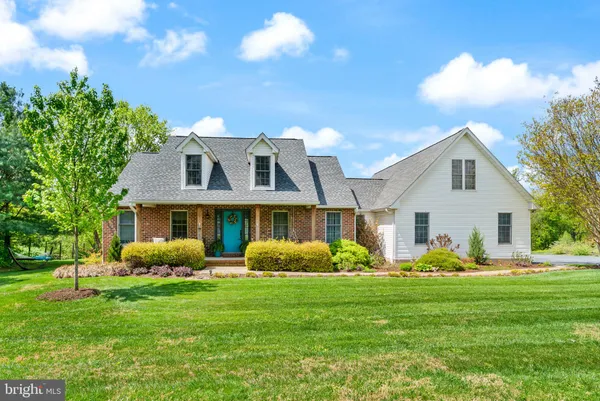 a front view of house with yard and green space