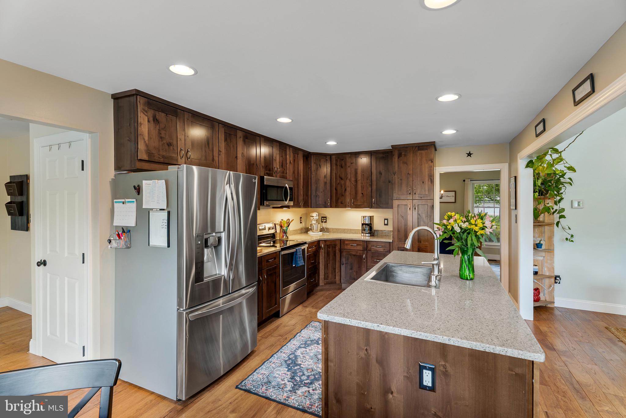 418 North Clear Ridge Road Union Bridge, MD 21791 - Photo 16 of 49 a kitchen with kitchen island a counter top space a refrigerator and a sink