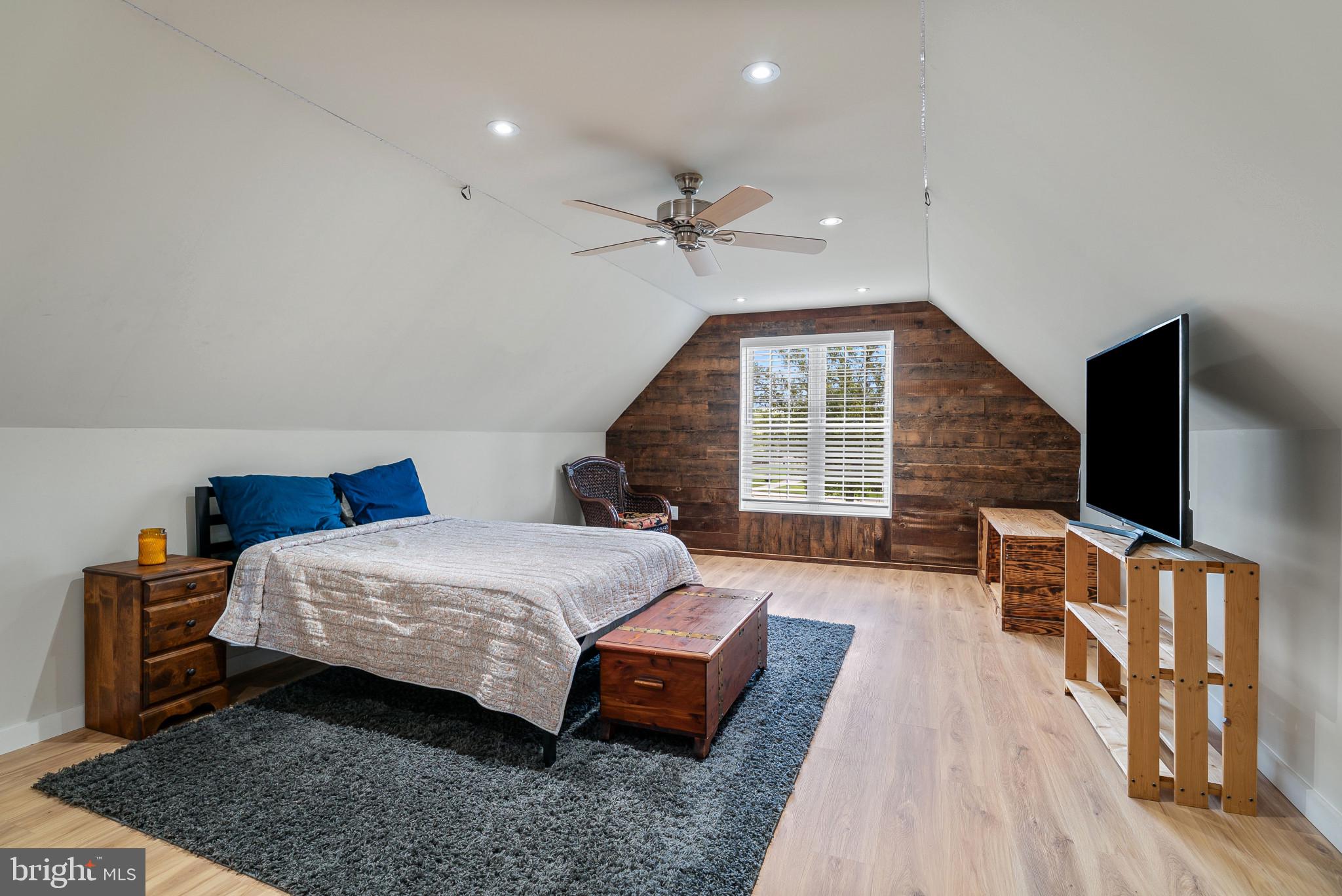 418 North Clear Ridge Road Union Bridge, MD 21791 - Photo 27 of 49 a spacious bedroom with a bed a dresser and a flat screen tv