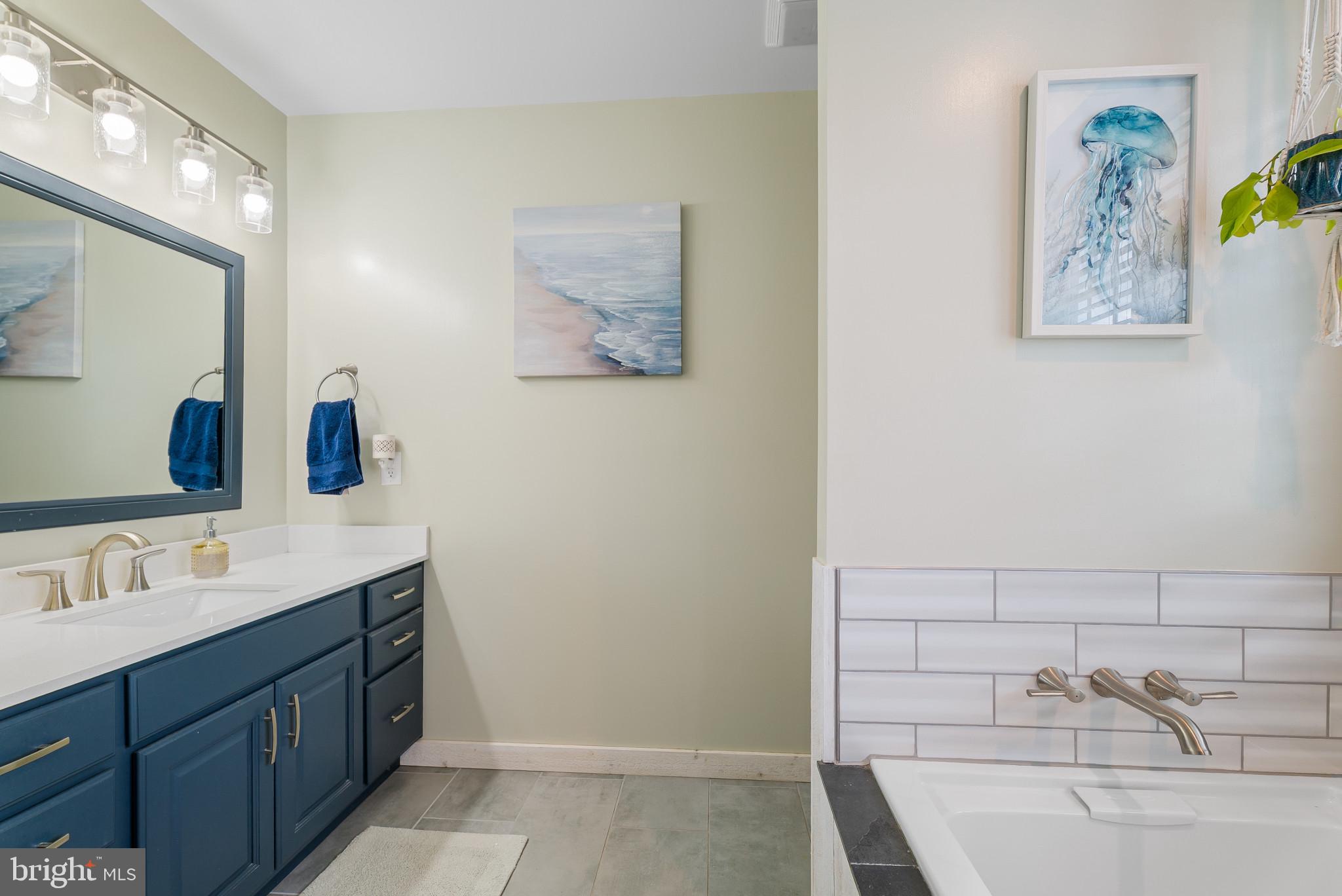 418 North Clear Ridge Road Union Bridge, MD 21791 - Photo 31 of 49 a spacious bathroom with a tub sink and mirror