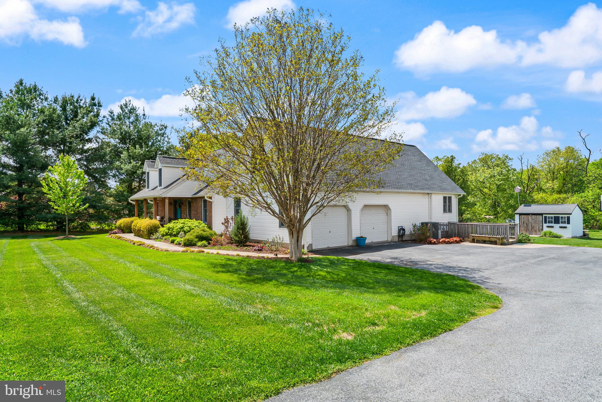 418 North Clear Ridge Road Union Bridge, MD 21791 - Photo 43 of 49 a front view of a house with garden and trees