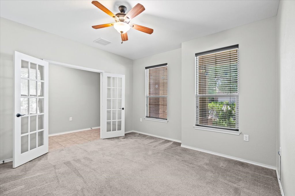 8804 Capitol View Drive Austin, TX 78747 - Photo 4 of 32 an empty room with windows and fan