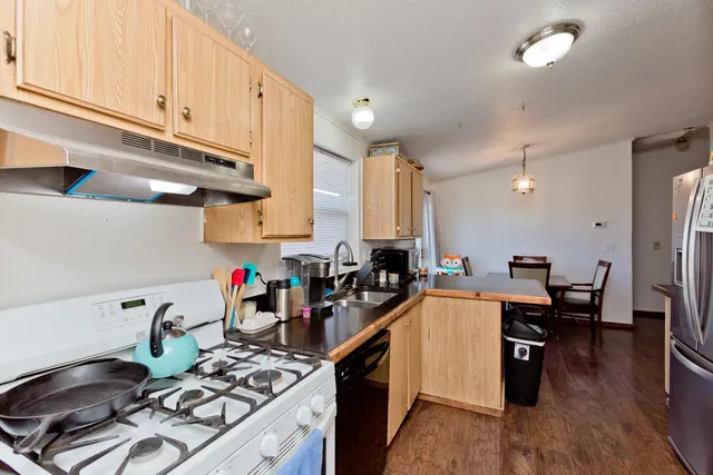 a kitchen with lots of counter top space and wooden floor
