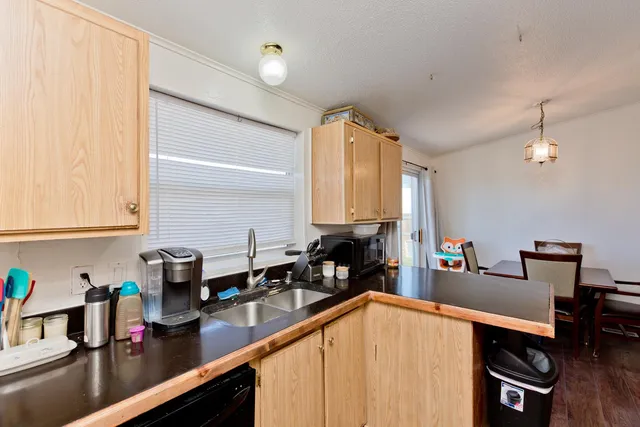 a kitchen with sink a stove and cabinets