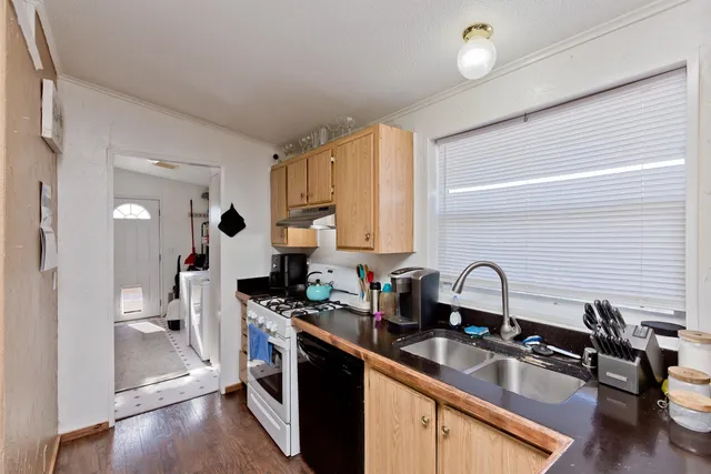 a kitchen with a sink appliances and cabinets