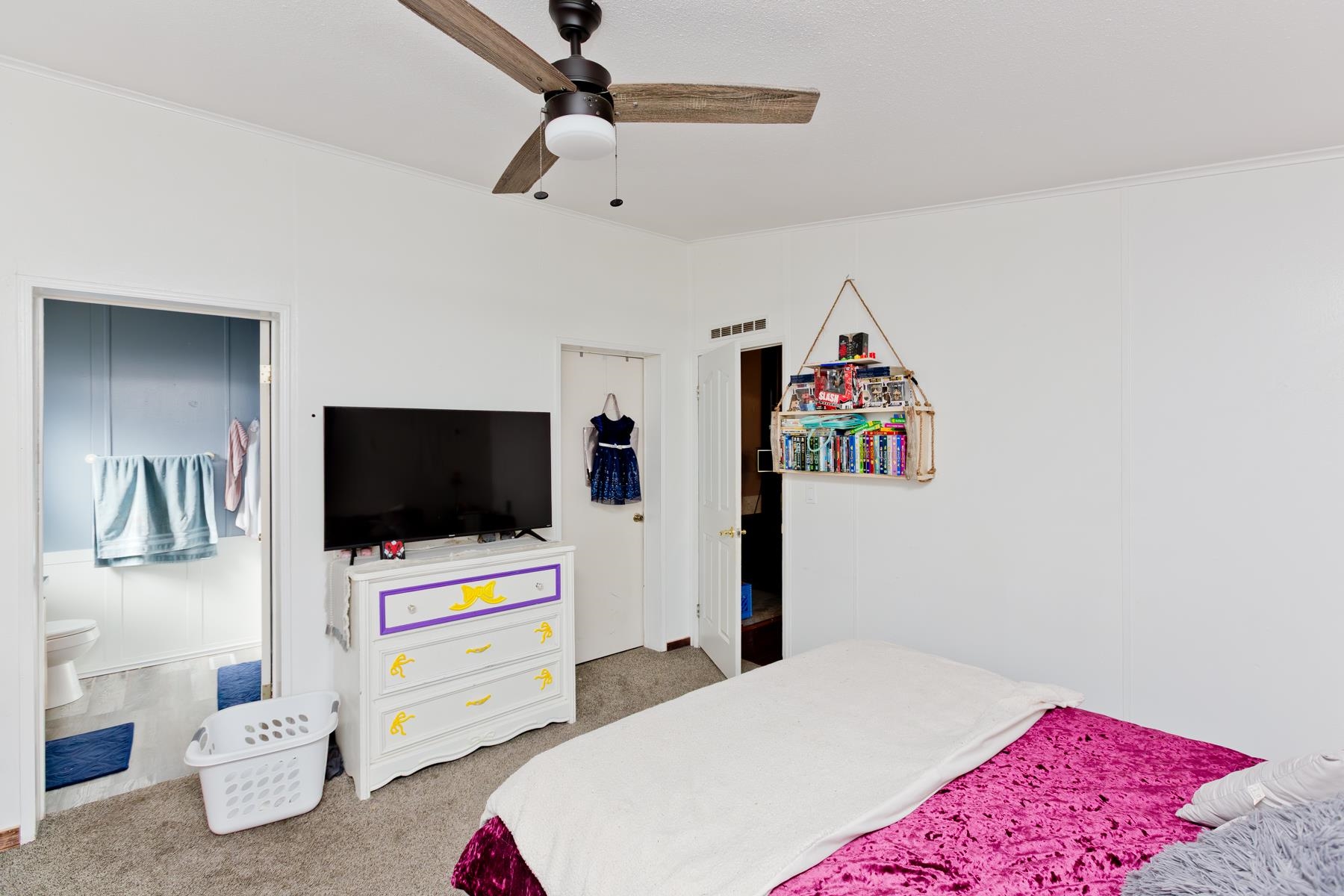 443 Florence Road Grand Junction, CO 81504 - Photo 20 of 40 a bedroom with a bed and a flat screen tv