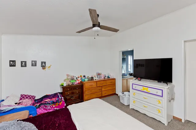 a bedroom with furniture and flat screen tv