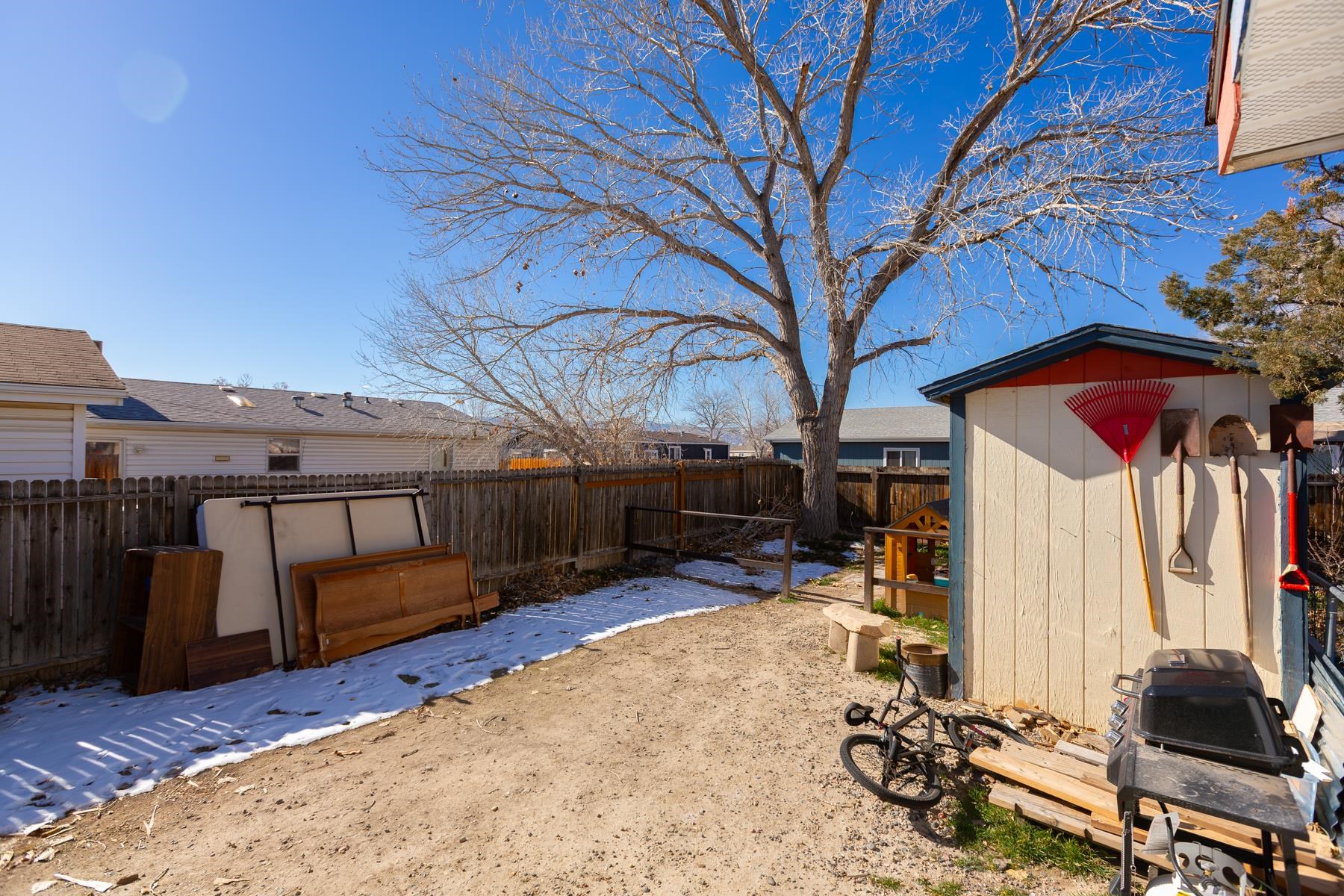 443 Florence Road Grand Junction, CO 81504 - Photo 39 of 40 a view of a backyard with table and chairs under an umbrella