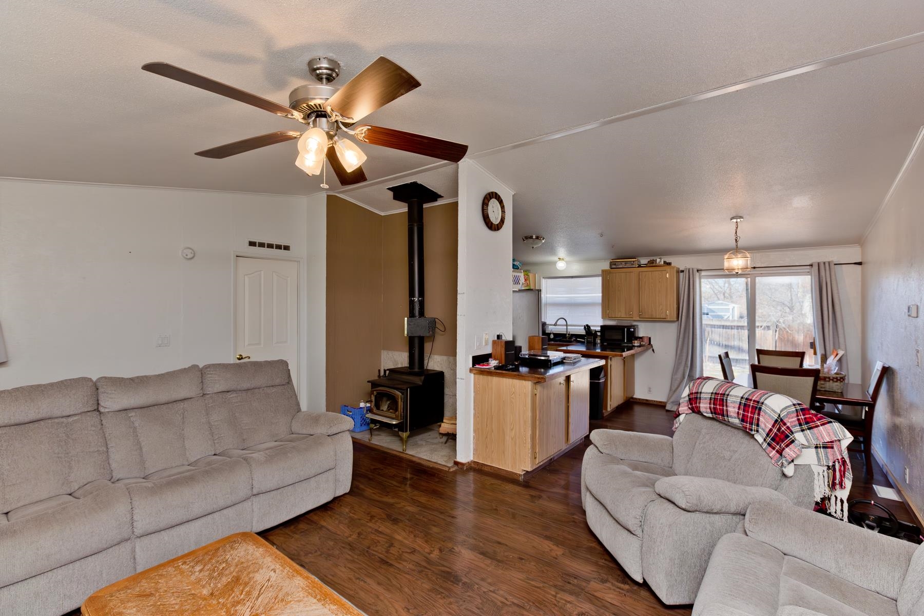 443 Florence Road Grand Junction, CO 81504 - Photo 6 of 40 a living room with couches a fireplace and kitchen view