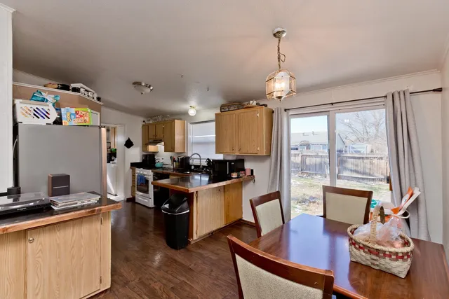 a open kitchen with stainless steel appliances granite countertop a stove and refrigerator