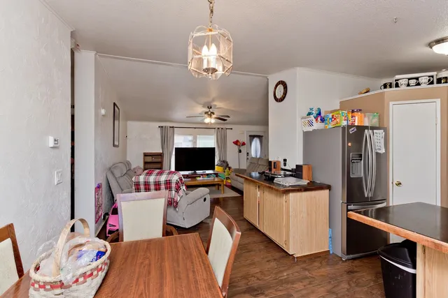 a view of a dining room with furniture and a kitchen