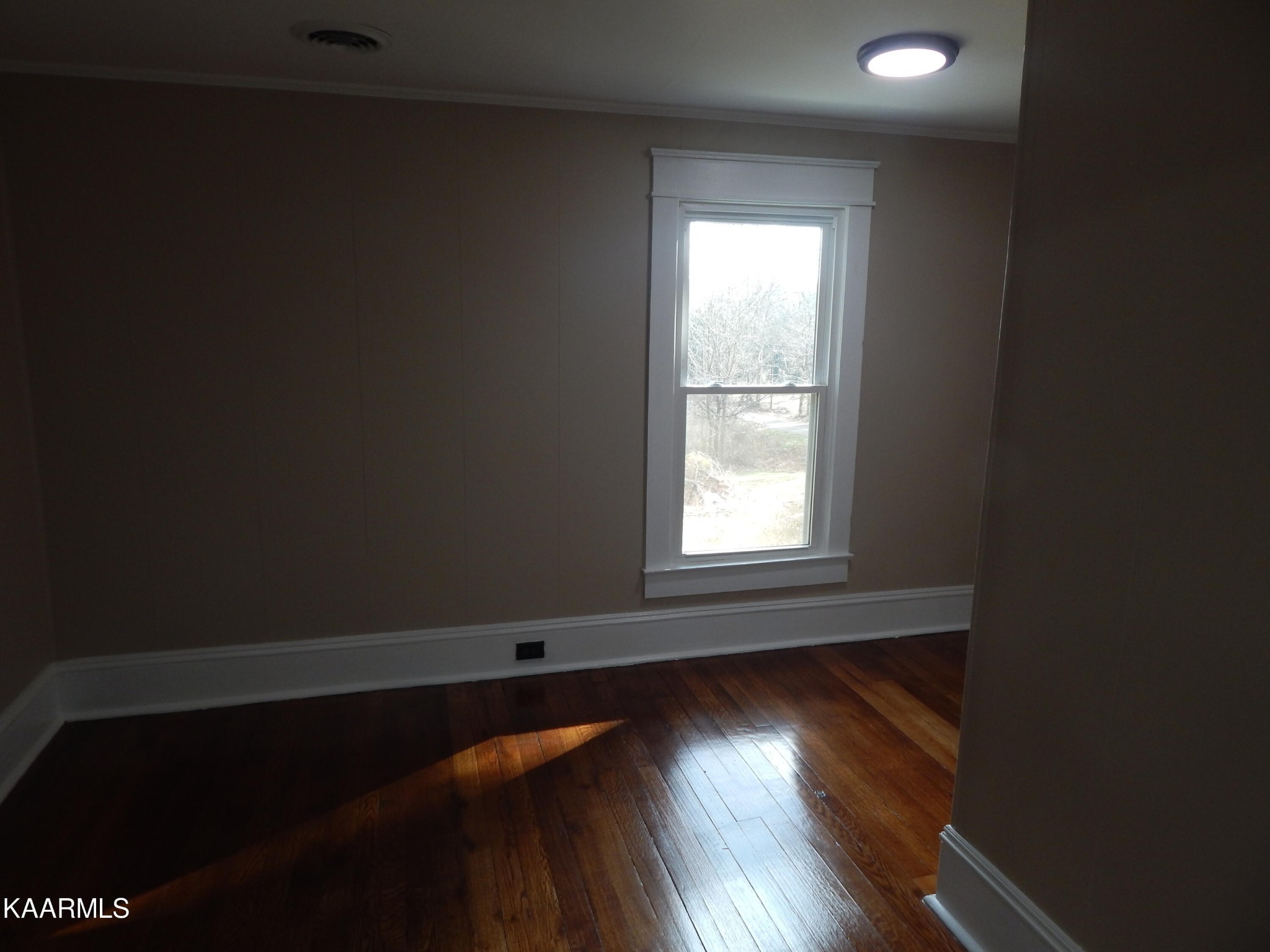367 Reed Road Greeneville, TN 37745 - Photo 38 of 51 a view of an empty room with wooden floor and a window