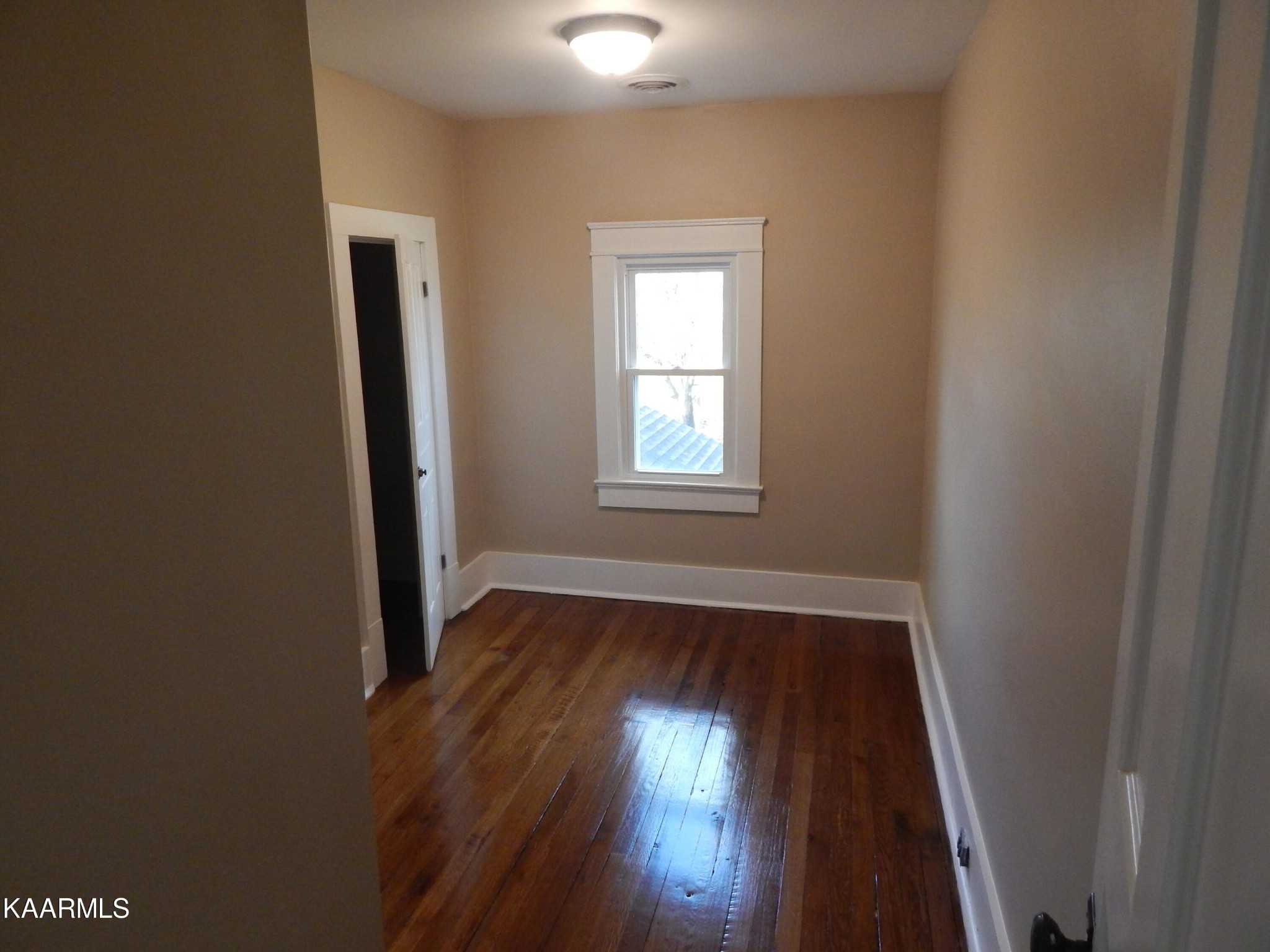 367 Reed Road Greeneville, TN 37745 - Photo 40 of 51 an empty room with wooden floor and windows
