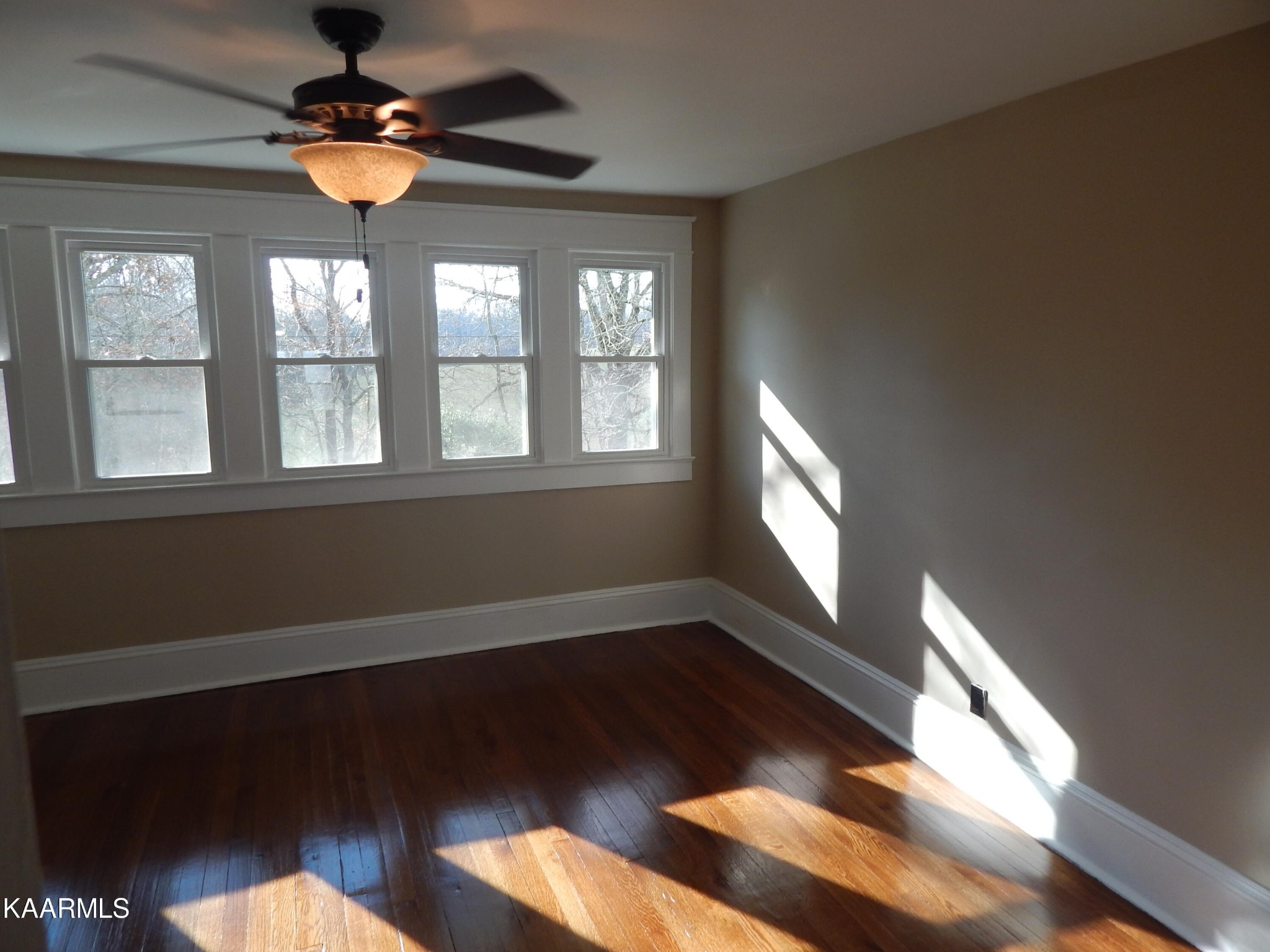 367 Reed Road Greeneville, TN 37745 - Photo 42 of 51 a view of an empty room with wooden floor and a window