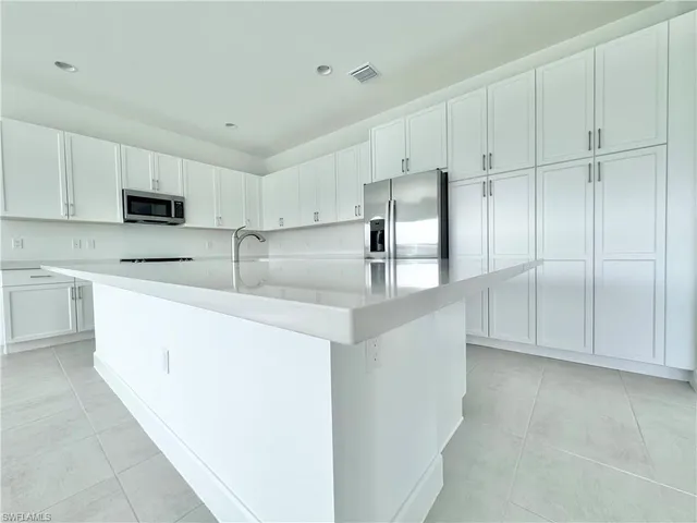 a white bath tub sitting next to a white sink