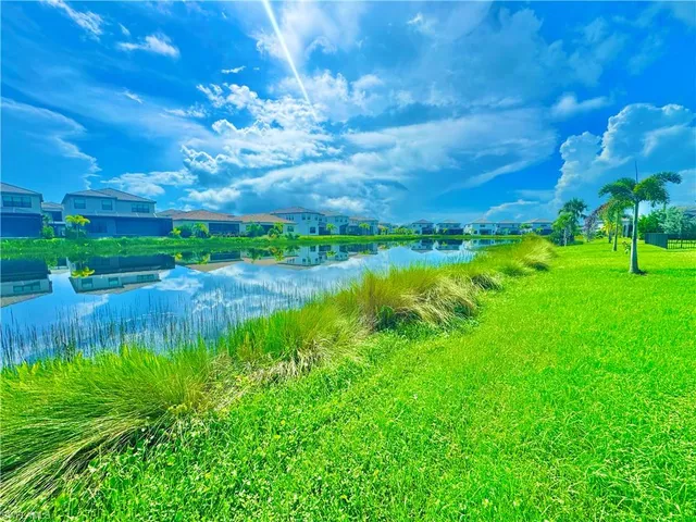 a kitchen with stainless steel appliances a refrigerator sink and white cabinets