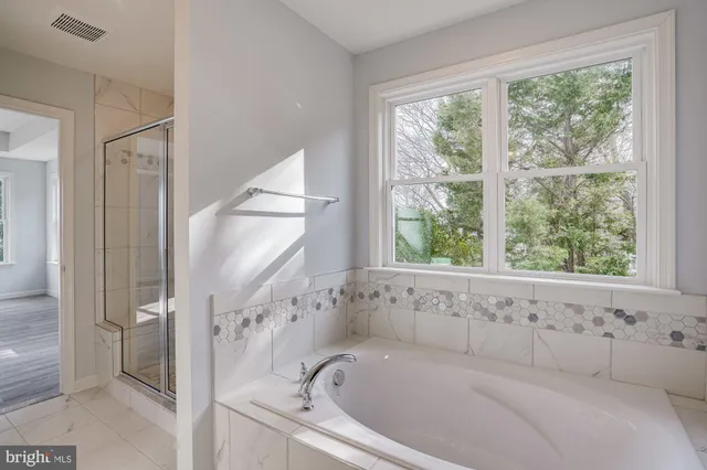 a bathroom with a glass shower door