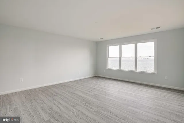 a view of an empty room and wooden floor