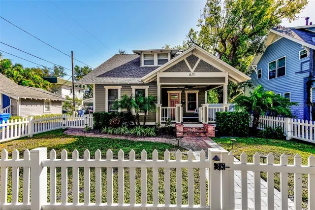 a front view of a house with porch and garden