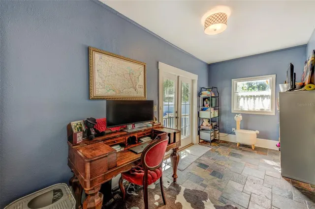 a room with furniture a flat screen tv and a window