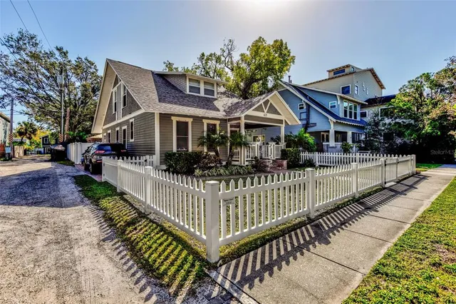 a front view of a house with wooden fence