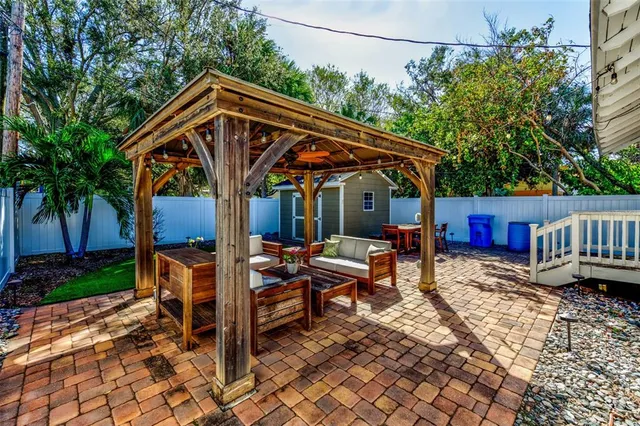 a backyard of a house with barbeque oven table and chairs
