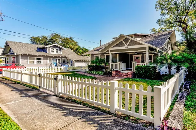 a front view of a house with wooden fence