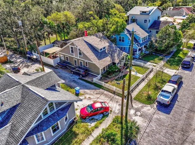 an aerial view of a house with a yard