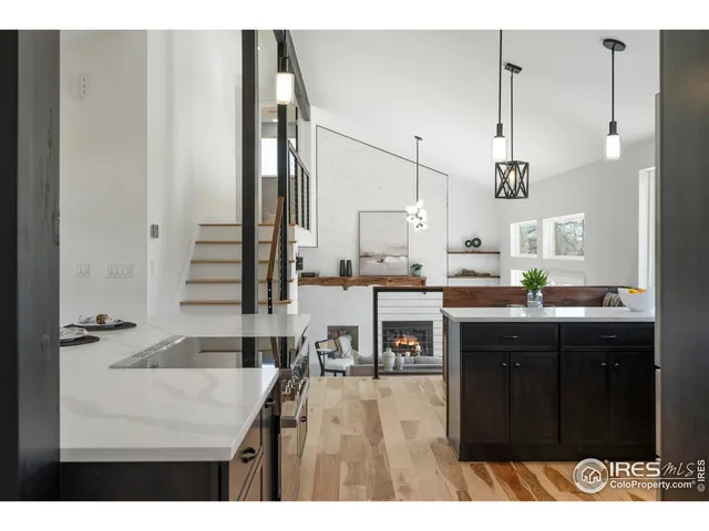a kitchen with kitchen island granite countertop a sink cabinets and stainless steel appliances