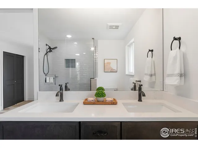 a bathroom with a sink double vanity and a mirror
