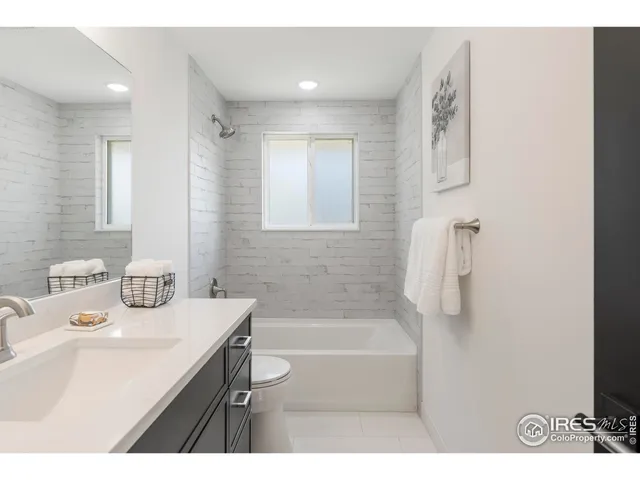 a bathroom with a sink a mirror and a bathtub