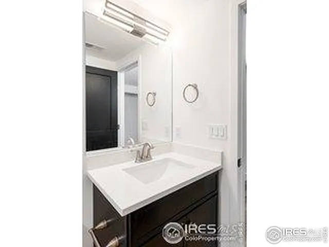 a bathroom with a sink a mirror and a vanity