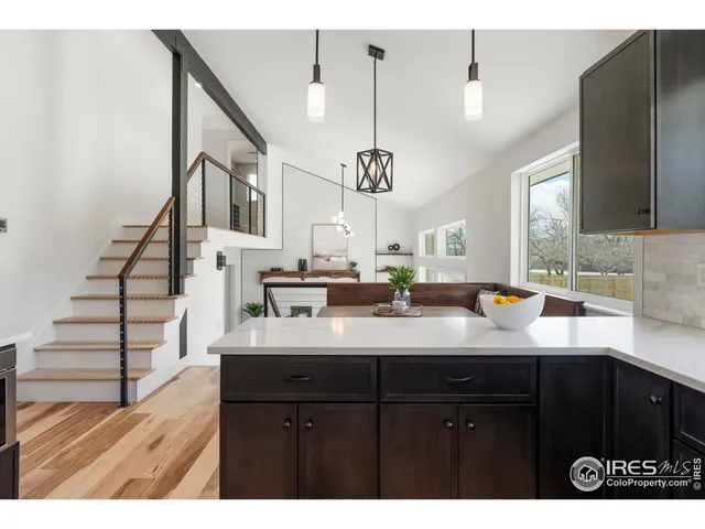 a kitchen with a sink a counter space and cabinets