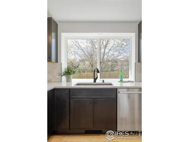 a kitchen with a sink and large window