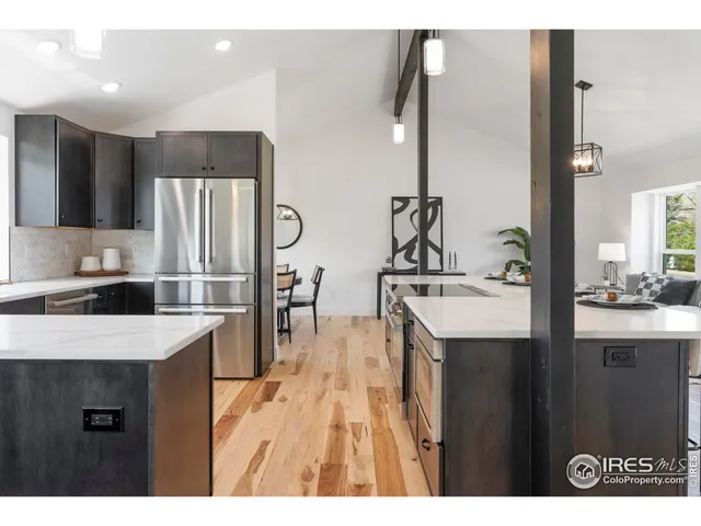 a kitchen with a sink a refrigerator and a kitchen island