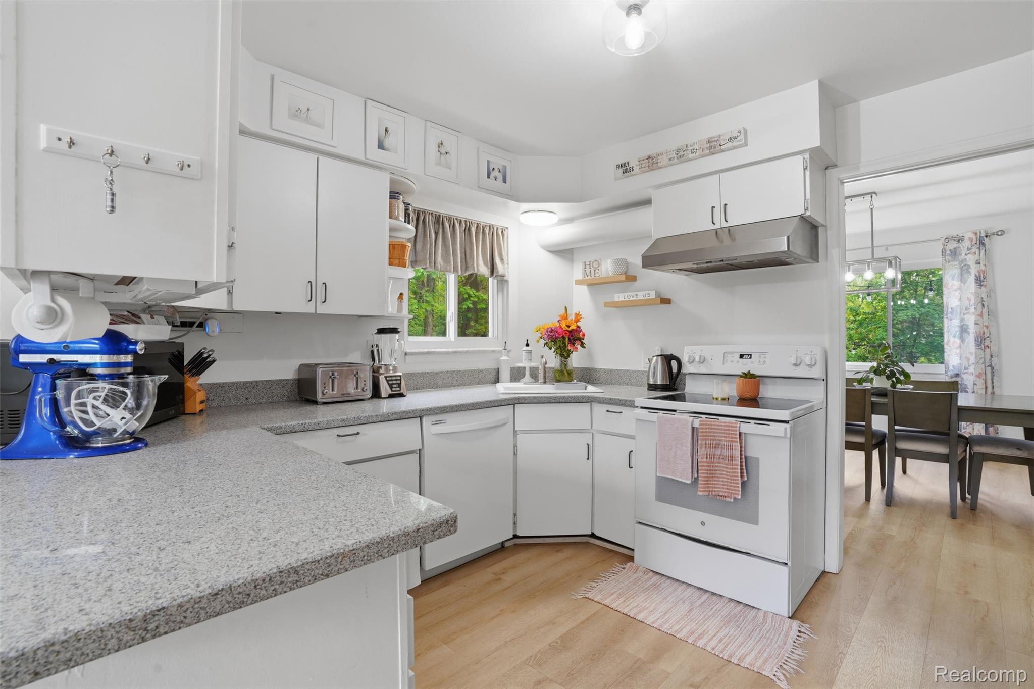 47129 Dunsany Road Northville, MI 48167 - Photo 13 of 49 Kitchen with white appliances, white cabinetry, open shelves, and light wood finished floors