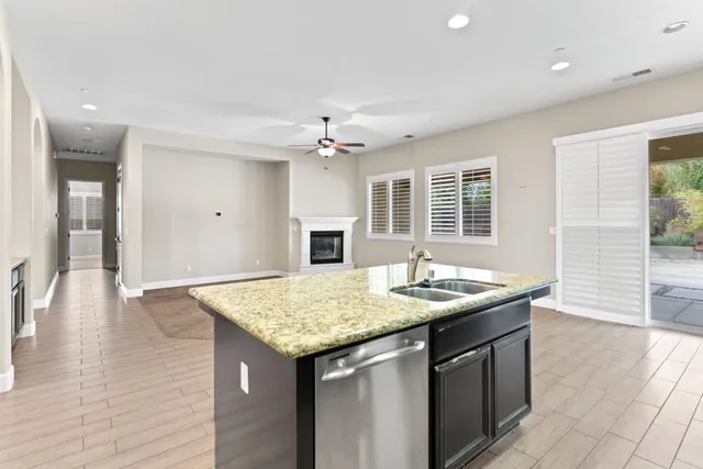 a kitchen with center island table and chairs